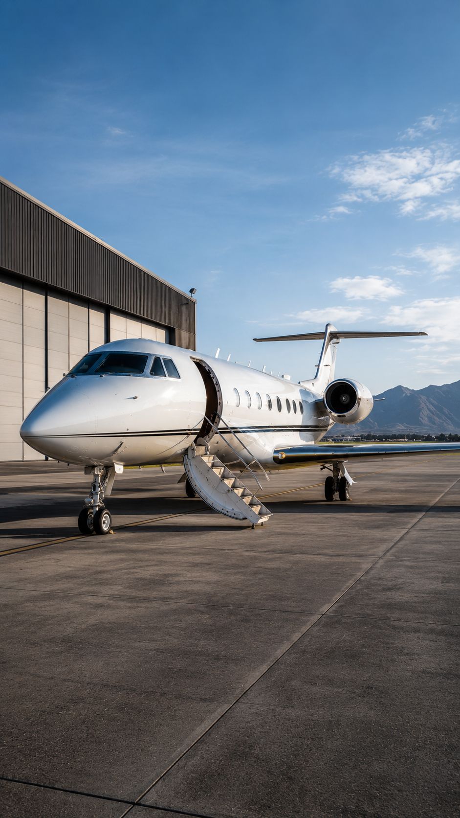 Private jet parked outside an airport hangar