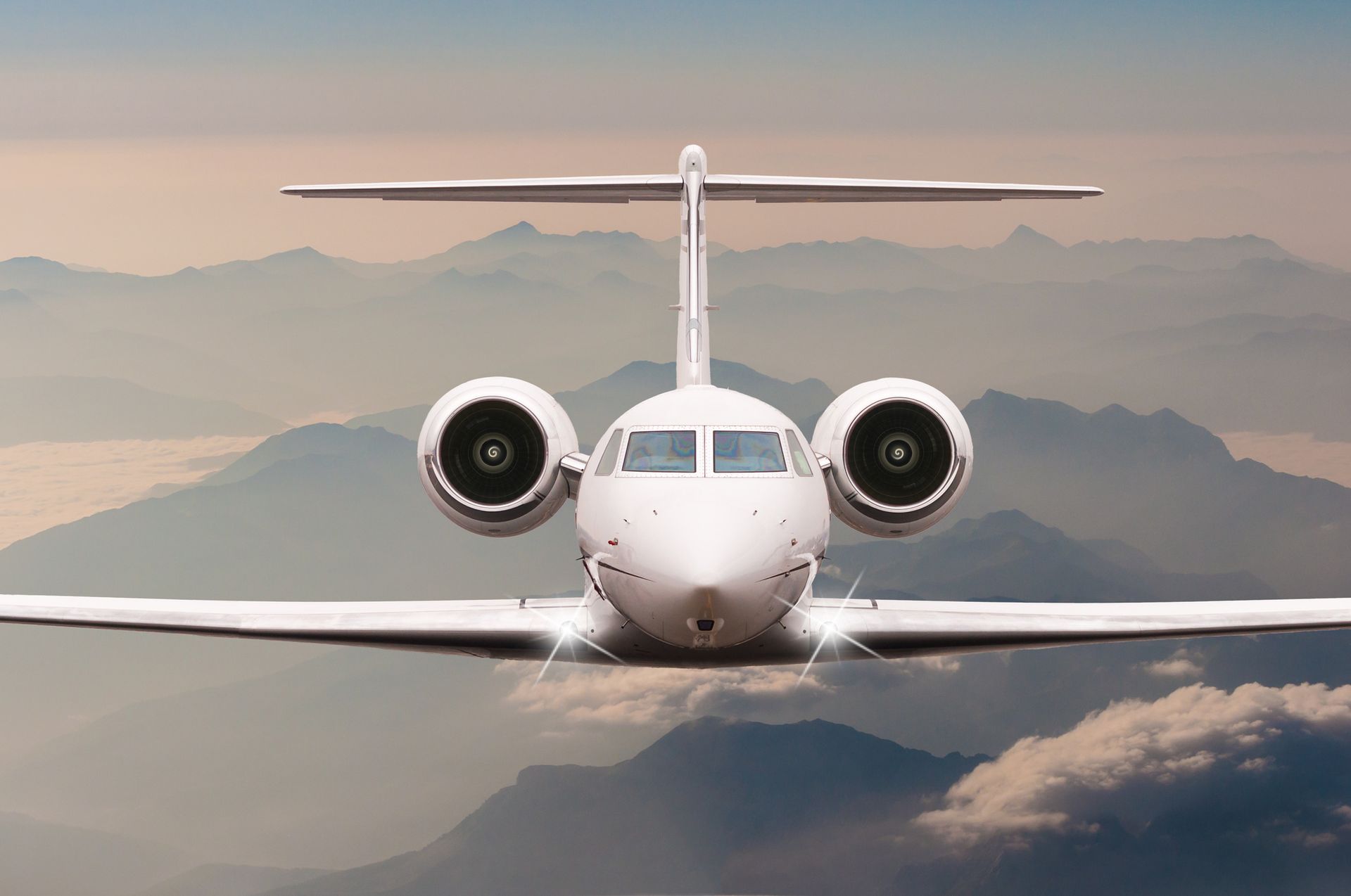 Two private jets parked on an airport runway