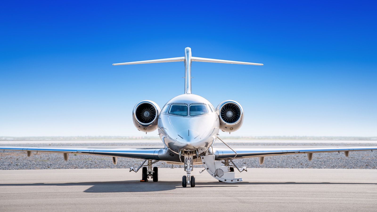 Front view of a private jet on an airport runway